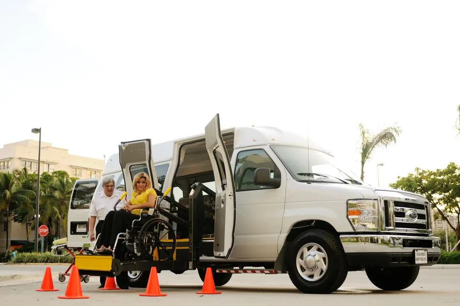 A wheelchair user boarding a vehicle via an accessibility lift, illustrative of accessible bus boarding