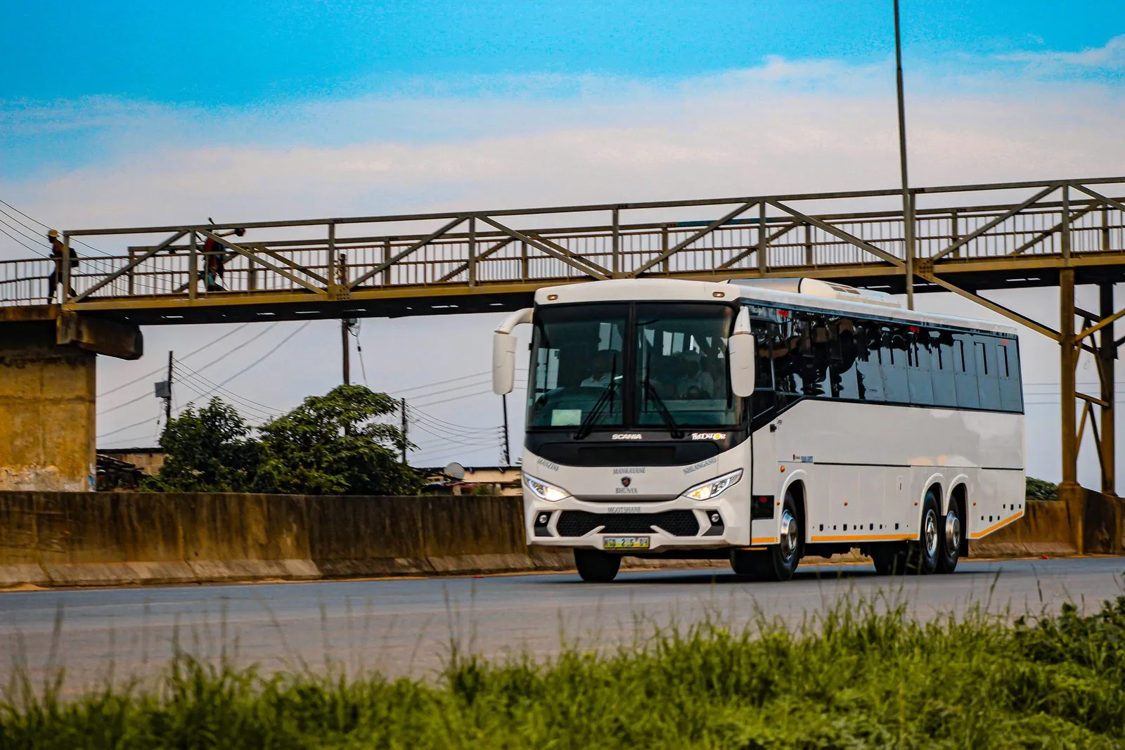 Intercity coach bus traveling on a highway, illustrative of long-distance budget bus travel