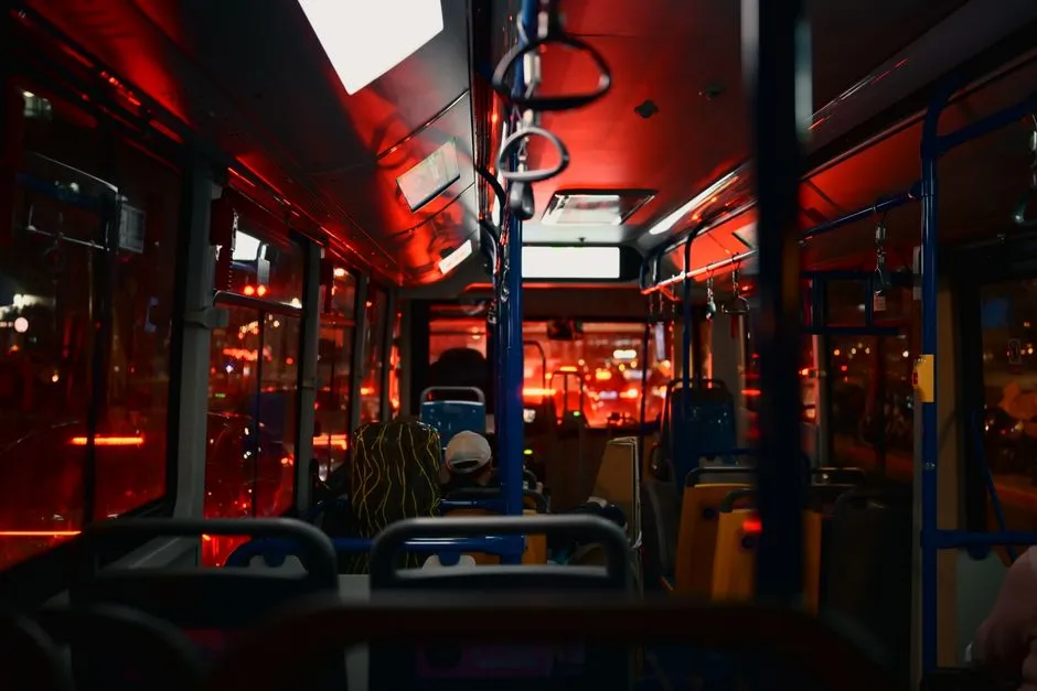 Interior of a city bus at night with passengers seated, illustrative of overnight intercity bus travel